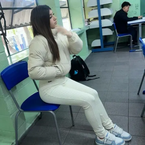 Jovem sentada em sala de aula