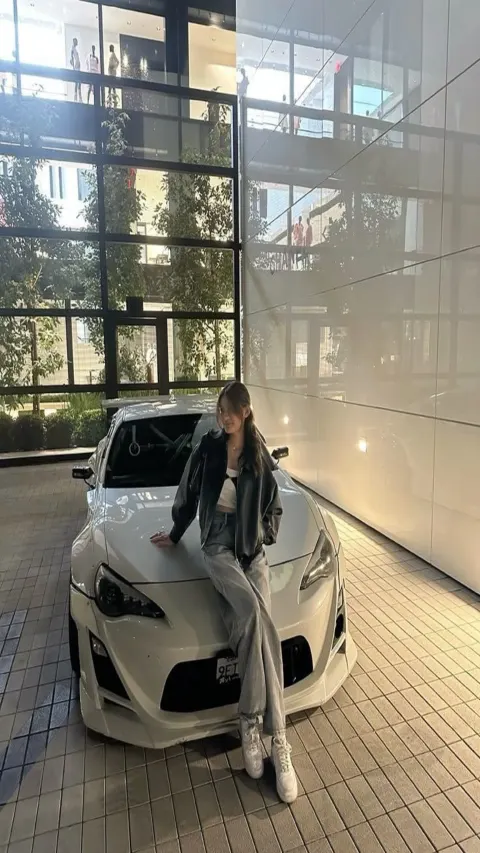 Garota posando em um Toyota 86 branco