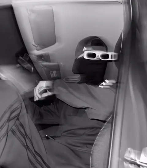 Jovem de máscara e óculos no carro